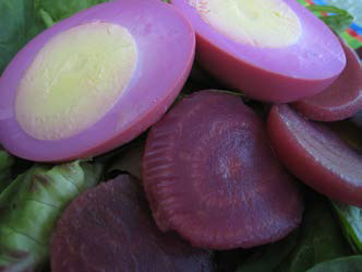 Pickled beets and eggs over lettuce.