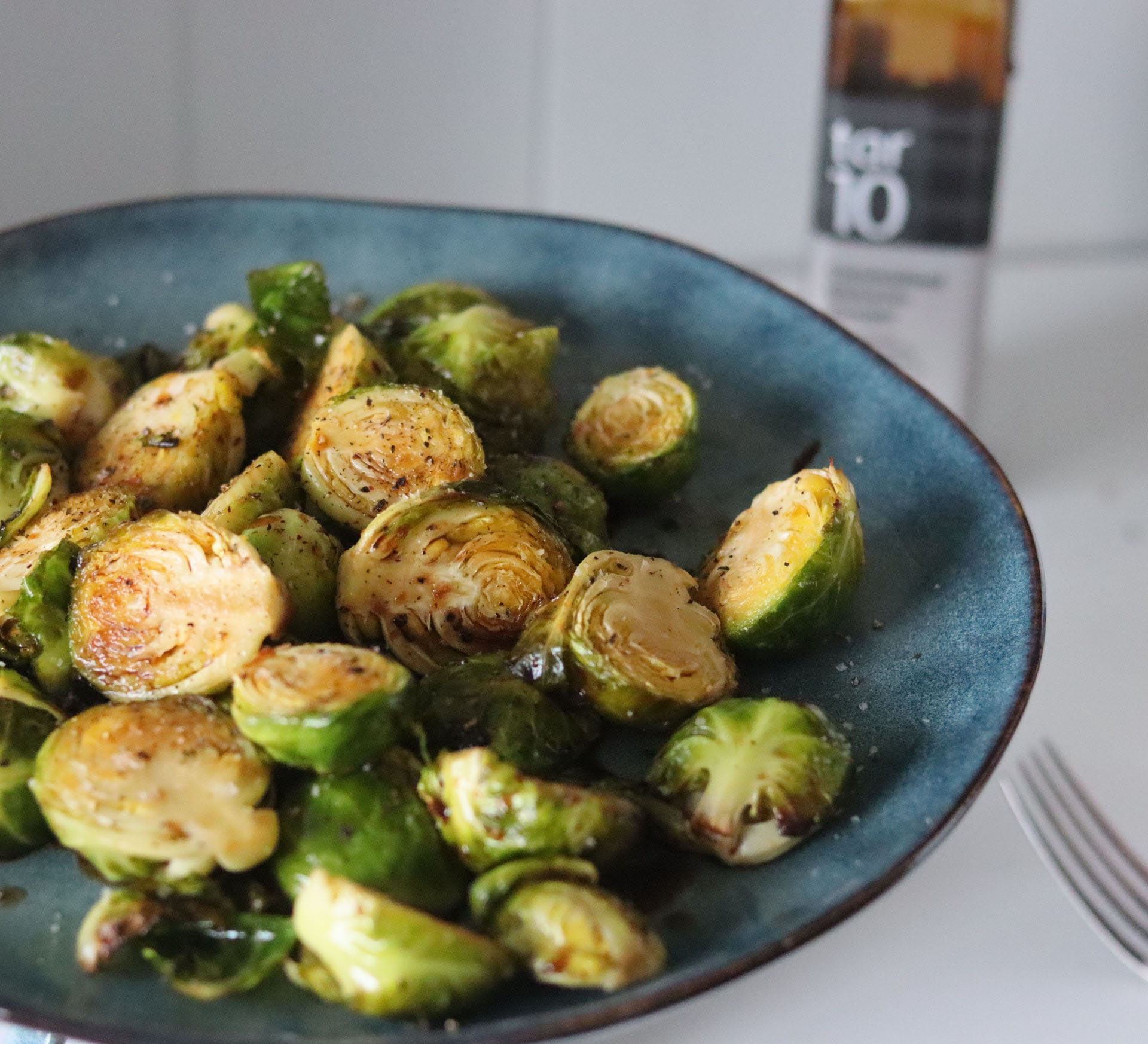 Brussel sprouts in a blue bowl.