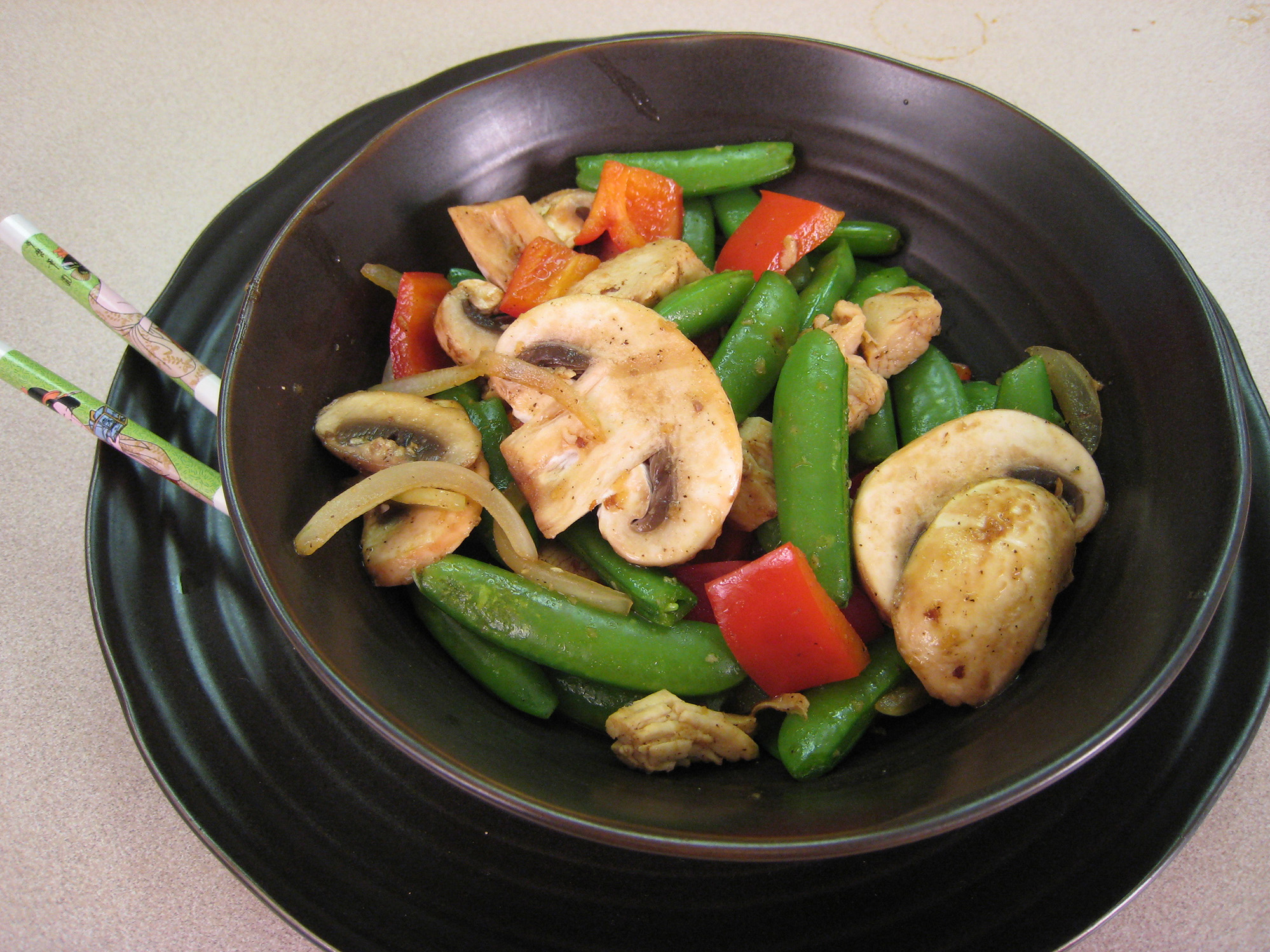 Stir-fry chicken and vegetables served in a bowl.