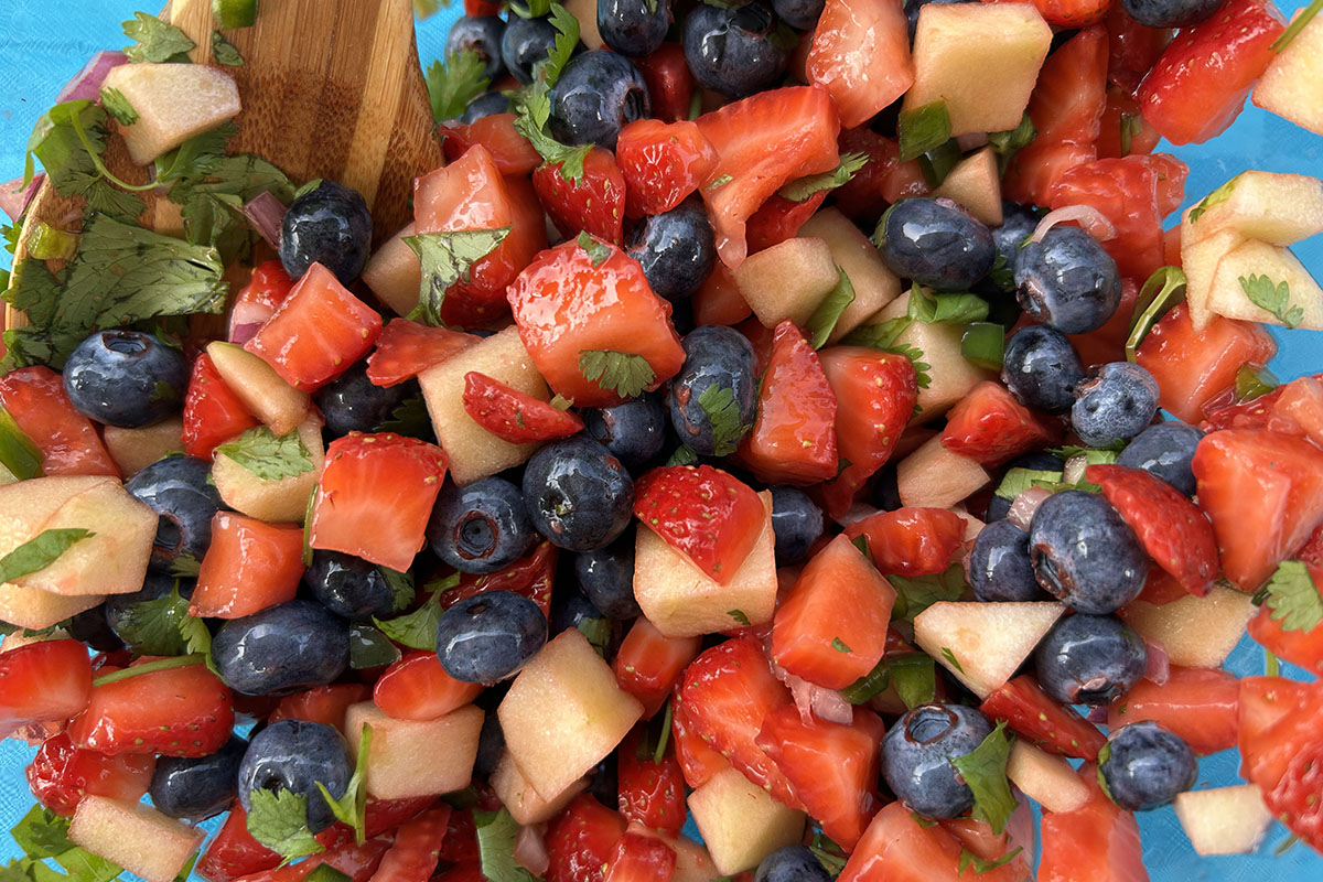 Top view of freshly chopped fruit beautifully arranged on a colorful plate.