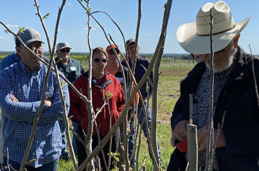 A goupe of people taking notes outside