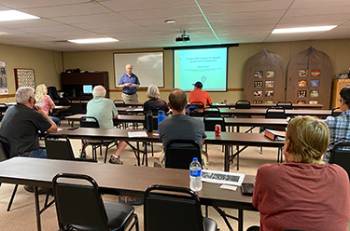 Students in a classroom with a instructor and a projector