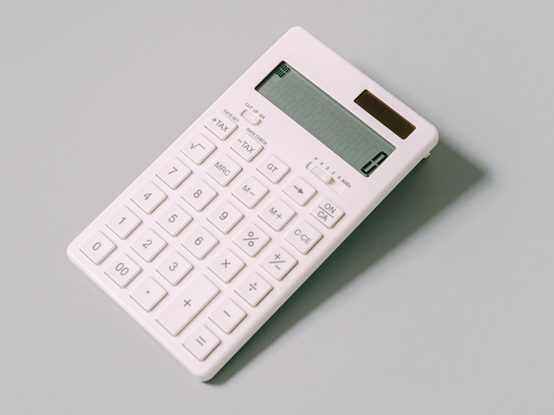 A calculator on a grey surface.