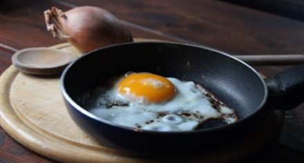 An egg being cooked in a cast iron skillet. An egg being cooked in a cast iron skillet.