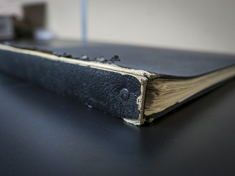 Old black binder with water damage.